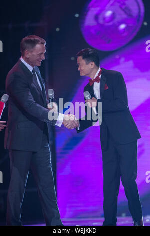 Jack Ma Yun, right, Chairman of Alibaba Group, shakes hands with English actor Daniel Craig during the 2015 Tmall 11.11 Global Shopping Festival gala Stock Photo