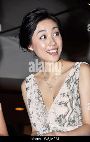 --FILE--Japanese actress Kazue Fukiishi reacts at a press conference for the opening of the Japanese Film Week during the 14th Shanghai International Stock Photo