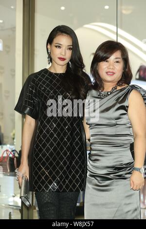 Taiwanese actress Shu Qi, left, poses during the opening ceremony for an MCM boutique in Taipei, Taiwan, 16 October 2015.