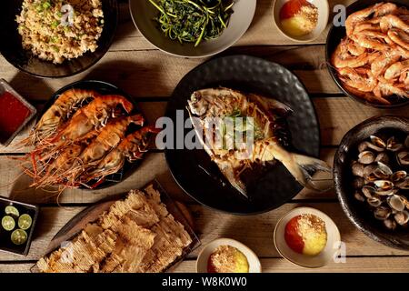 Asian Seafood Dinner. Assorted seafood dishes prepared in Peranakan style. Stock Photo