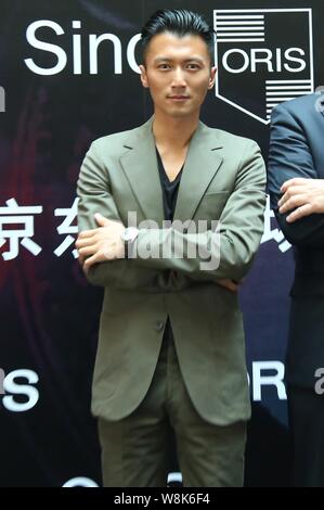 Hong Kong singer and actor Nicholas Tse poses during the opening