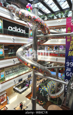 The five-story-high giant winding slide is pictured at the Bali Chuntian  (Paris Spring) Department Store owned by New World Department Store China  Lim Stock Photo - Alamy