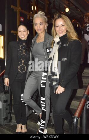 Hong Kong-born American singer Coco Lee, right, poses with British singer Rita Ora, center, as she feasts Rita at her restaurant in Hong Kong, China, Stock Photo