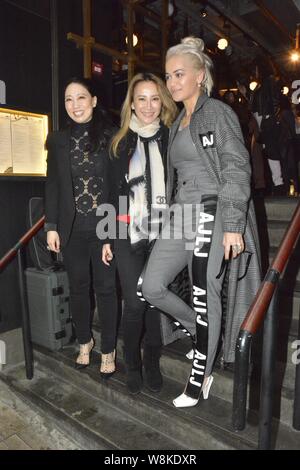 Hong Kong-born American singer Coco Lee, center, poses with British singer Rita Ora, right, as she feasts Rita at her restaurant in Hong Kong, China, Stock Photo