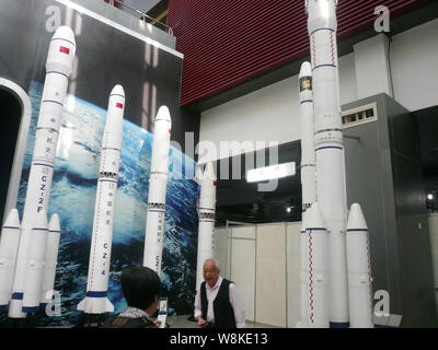 --FILE--Chinese visitors look at models of China's Long March-series carrier rockets on display at a museum in Chengdu city, southwest China's Sichuan Stock Photo