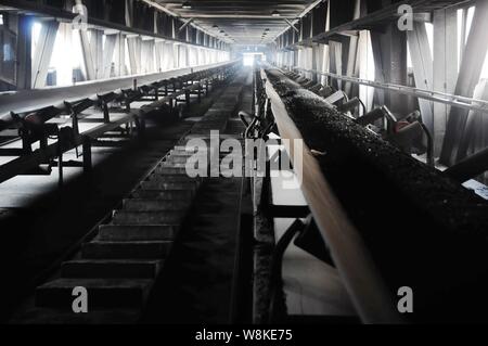 --FILE--View of coal being transported by belt conveyor at a coal-fired power plant in Qingdao city, east China's Shandong province, 28 October 2011. Stock Photo