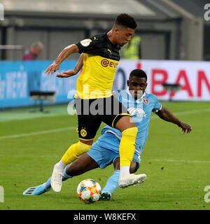 Uerdingen, Germany. 9th Aug, 2019. Jadon Sancho (L) of Dortmund vies with Franck Evina of Uerdingen during the German Cup first round match between Borussia Dortmund and KFC Uerdingen 05 in Uerdingen, Germany, Aug. 9, 2019. Credit: Joachim Bywaletz/Xinhua/Alamy Live News Stock Photo