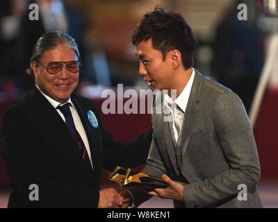 Hong Kong tycoon Timothy Fok Tsun-Ting, left, shakes hands with Hong Kong bowling player Wu Siu Hong during the 2015 Hong Kong Sports Star Awards in H Stock Photo