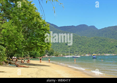 Ilha Grande, Rio de Janeiro State, Brazil - January 30, 2009: beach goers on the sand and on the water on a tropical island, Ilha Grande, Rio de Janei Stock Photo