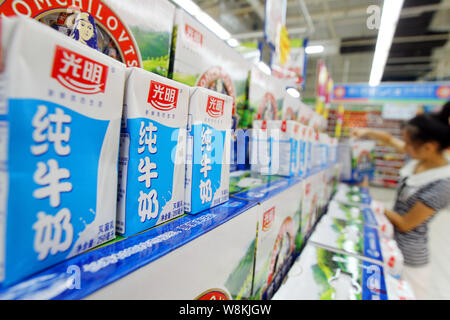 --FILE--A Chinese customer shops for milk of Bright Dairy at a supermarket in Nantong city, east China's Jiangsu province, 15 August 2014.  Bright Dai Stock Photo