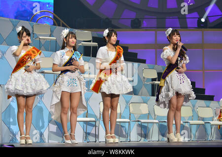 --FILE--Tang anqi, right, and other members of Chinese idol girl group SNH48 attend a concert for the annual idol popularity poll in Shanghai, China, Stock Photo