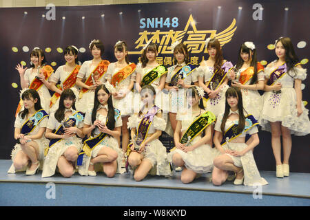 --FILE--Tang anqi, back third right, and other members of Chinese idol girl group SNH48 attend a concert for the annual idol popularity poll in Shangh Stock Photo