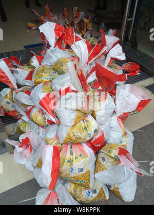 Sacks of coins are piled at a branch of Dongyang Rural Commercial Bank before the money is deposited in Dongyang city, east China's Zhejiang province, Stock Photo