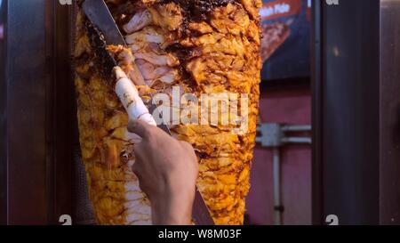 Shawarma. Closeup picture of stacked meat roasting, shawarma. Stock Photo