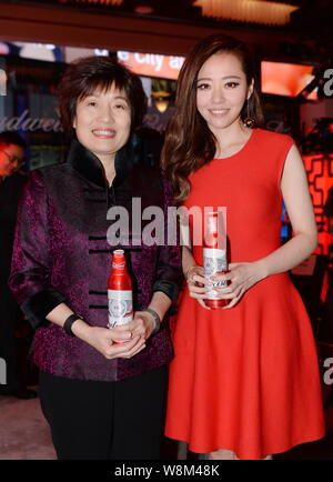 Chinese singer Zhang Liangying, right, poses during a promotional event for Budweiser on the Times Square in New York city, USA, 26 January 2016. Stock Photo