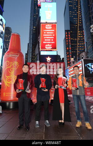 Chinese singer Zhang Liangying, second right, poses during a promotional event for Budweiser on the Times Square in New York city, USA, 26 January 201 Stock Photo