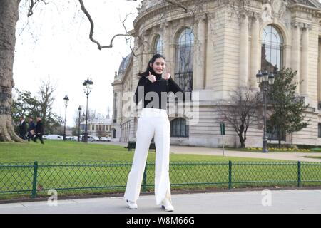 Chinese model Xi Mengyao poses for street snap after the Chanel fashion show during the Paris Haute Couture Fashion Week Spring/Summer 2016 in Paris, Stock Photo