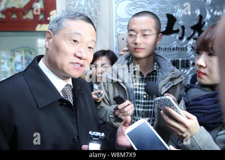 --FILE--Xiao Gang, left, Chairman of the China Securities Regulatory Commission (CSRC), is interviewed as he arrives at a panel discussion during the Stock Photo