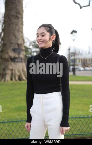 Chinese model Xi Mengyao poses for street snap after the Chanel fashion show during the Paris Haute Couture Fashion Week Spring/Summer 2016 in Paris, Stock Photo