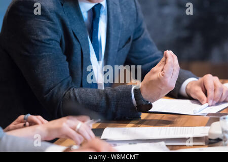 closeup shot of business people hands using pen while taking notes on education training during business seminar at modern conference room Stock Photo