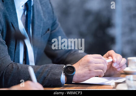 closeup shot of business people hands using pen while taking notes on education training during business seminar at modern conference room Stock Photo