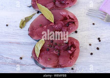 Raw traditional tuna fish-Bonito fish and spices for cooking on a old wooden background/ Preparation food - Image Stock Photo