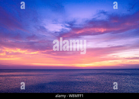 Colorful sunset sky over the ocean with dramatic cloud formation Stock Photo