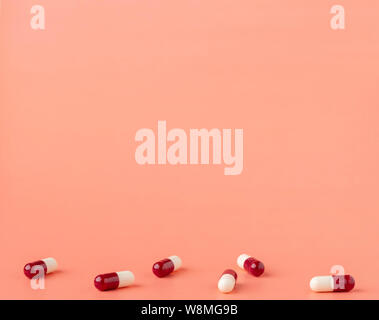 Scattering of red and white drug capsules Stock Photo