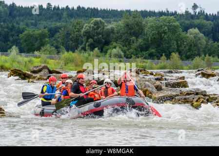 River rafting with families and children on the river Iller in the Allgäu alps Stock Photo