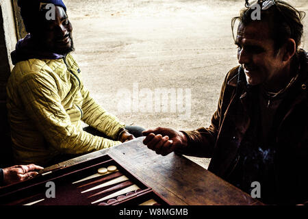 Playing the board game Backgammon on the Cape Peninsula in Glencairn, South Africa, near Cape Town Stock Photo