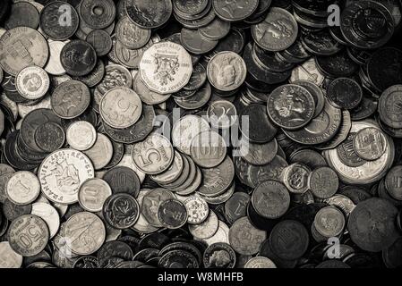 Coins in black and white, international collection. Coin background. Stock Photo