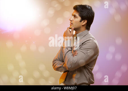 Businessman standing with his arms crossed and thinking Stock Photo