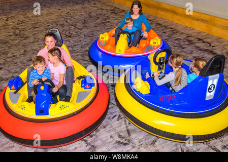 Scooter driving with the kids in indoor playground Stock Photo