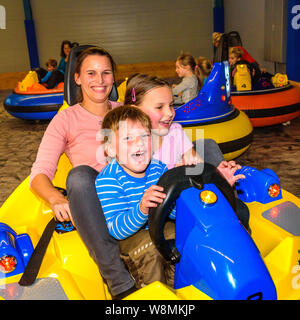 Scooter driving with the kids in indoor playground Stock Photo