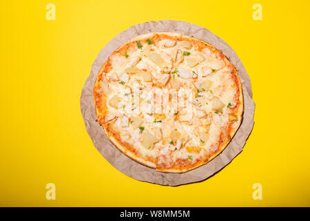 Fresh pizza isolated on yellow background. Flat lay photo. Stock Photo