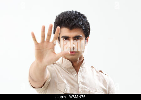 Young man making stop gesture Stock Photo
