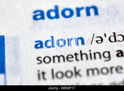 MONTREAL, CANADA - JULY 17, 2019: adorn word in a dictionay with meaning. Close-up and selective focus. Stock Photo