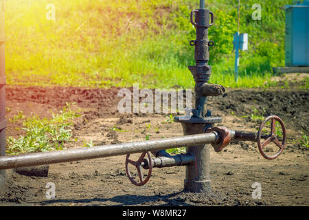 Oil and gas processing plant with pipe line valves. Oil pipeline valves in the oil and gas industry. Valve plug an oil pipeline in the field on a sunn Stock Photo