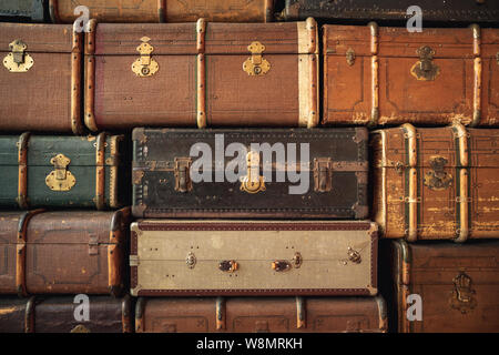 Retro luggages bag background. Pile of colorful vintage suitcases Stock Photo