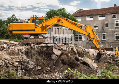 tracked excavator loading the material in a truck Stock Photo