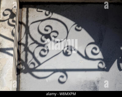 Solar glare and shadows on the wall from the leaves. Stock Photo