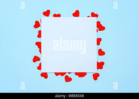 Abstract red wooden heart clip with Blank paper and stick paper on pastel blue background. paper note copy space for add text. education or valentine Stock Photo