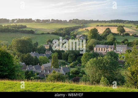 Looking over Naunton village in the evening summer light. Naunton, Cotswolds, Gloucestershire, England Stock Photo