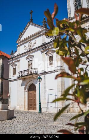 Old Portuguese street. Classic architecture and church from Portugal. Vintage cultural style. Stock Photo