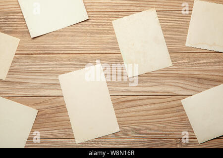 Old photo, blank template for picture, mock-up. Wooden background Stock Photo