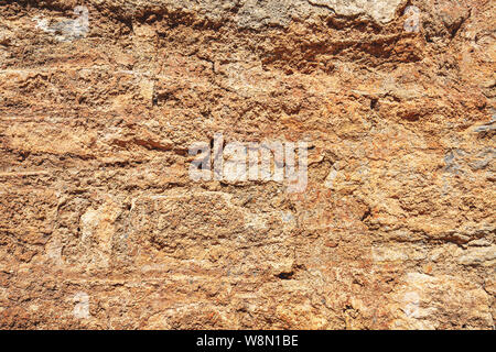 Old damaged stone wall with plaster, ancient wall background Stock Photo