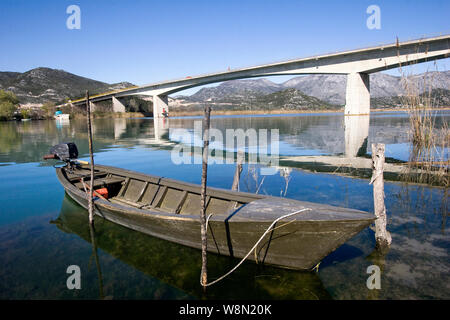 Traditional little green boat in Neretva river near Rogotin bridge Stock Photo