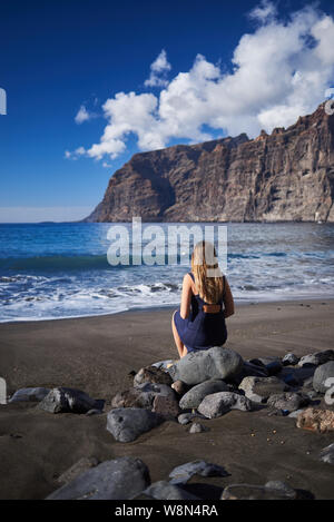 Young woman in Los Gigantes beach in Tenerife, Canary Islands, Spain Stock Photo