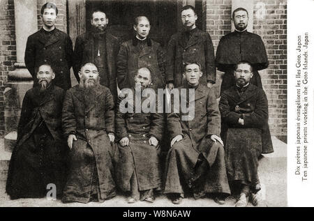 [ 1920s Japan - Japanese Catholic Priests ] —   Ten Japanese Catholic priests working on the Goto Islands. In the 17th century Japanese Christians escaped persecution by going underground. They were rediscovered when Christianity re-entered Japan during the second half of the 19th century and became known as 'Kakure Kirishitan' (Hidden Christians). The Catholic Church paid a lot of attention to them.  20th century vintage postcard. Stock Photo