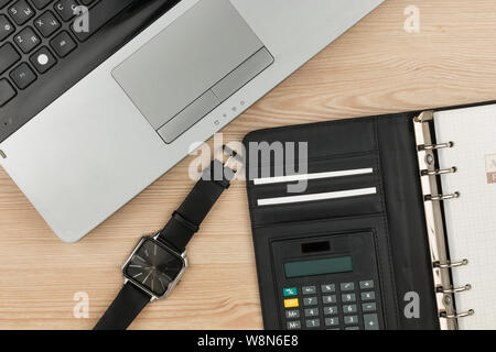 Top view of a desktop. Wristwatch, organizer and laptop. Desktop, business background Stock Photo